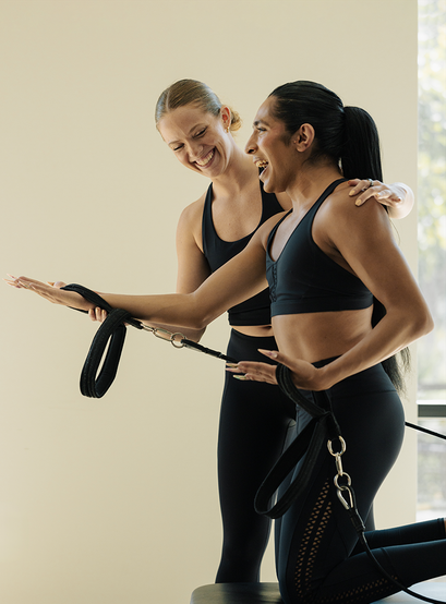 Woman working out with a trainer while pregnant at FS8